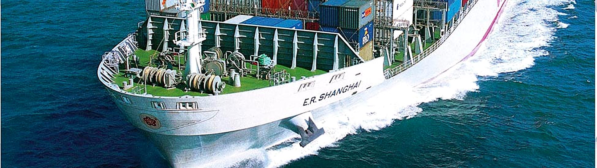 Container vessel cutting through open water at speed